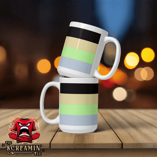 Cassgender Pride Mug stacked on a wooden table with blurred lights in the background.