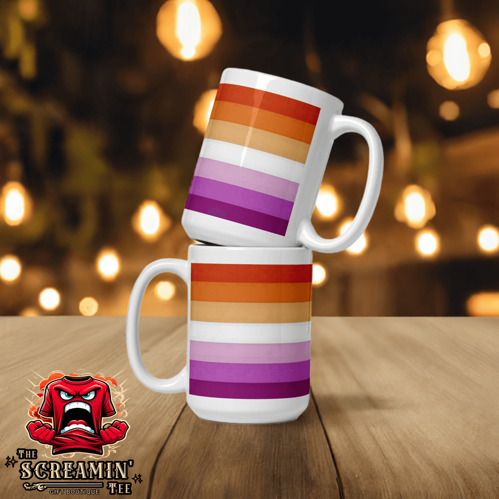 Two Lesbian Pride Mugs stacked, featuring vibrant rainbow stripes on a wooden table, perfect for coffee or tea.