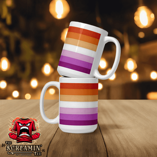 Two Lesbian Pride Mugs stacked, featuring vibrant rainbow stripes on a wooden table, perfect for coffee or tea.