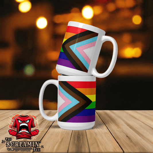 Progress Inclusive Pride Mug showcasing vibrant colors on a sturdy ceramic design, perfect for coffee or tea.